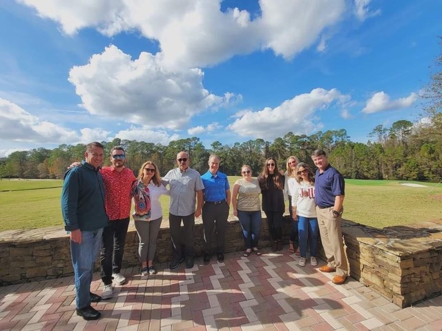 A group of employees posing for a photo.